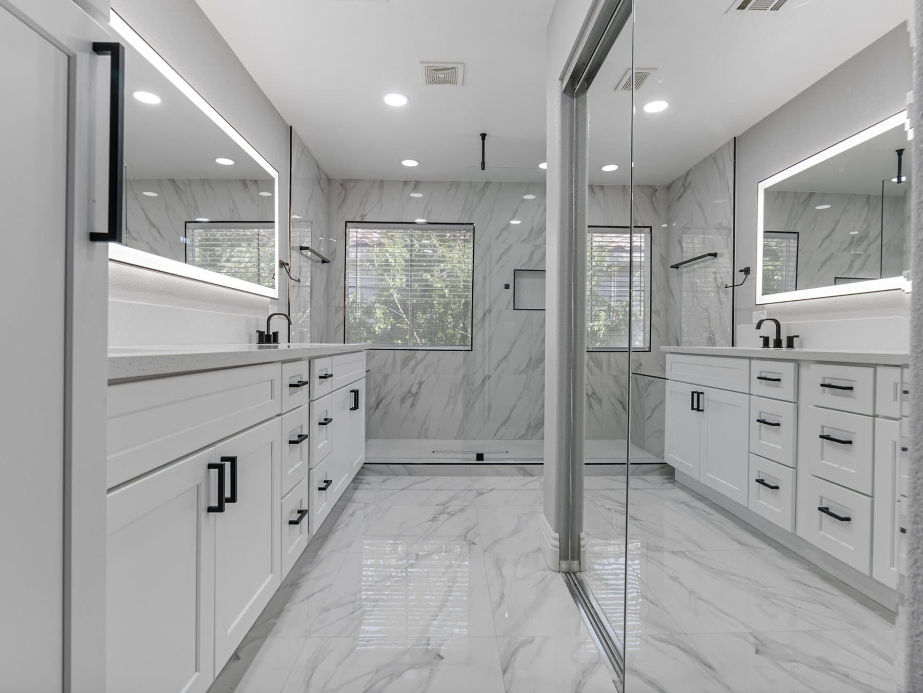 Summerlin bathroom remodel: long double-vanity bathroom with illuminated mirrors